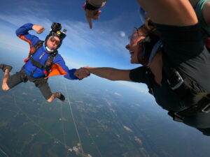 Tandem skydiving videographer in freefall at Skydive Chicago