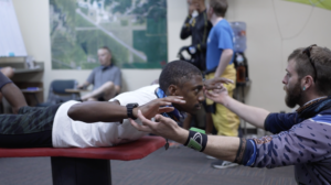 A skydiving student with an instructor for ground training at Skydive Chicago