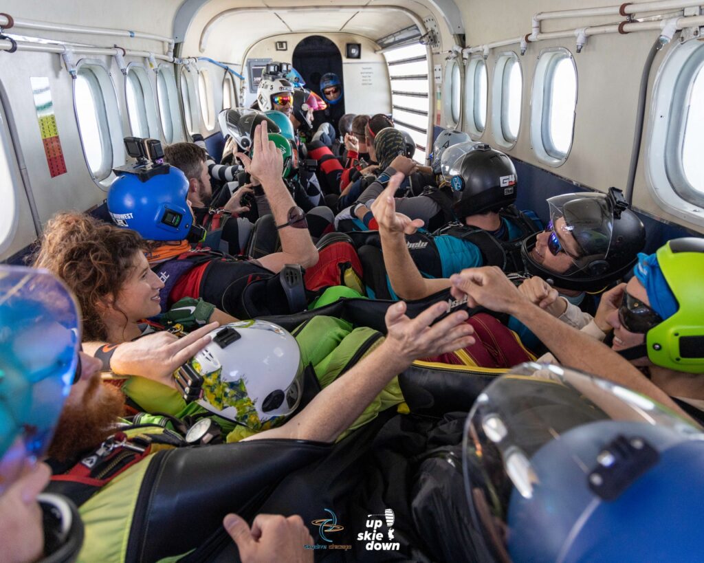 skydivers fist bump and handshake before exiting the plane at skydive chicago during the Summerfest Boogie