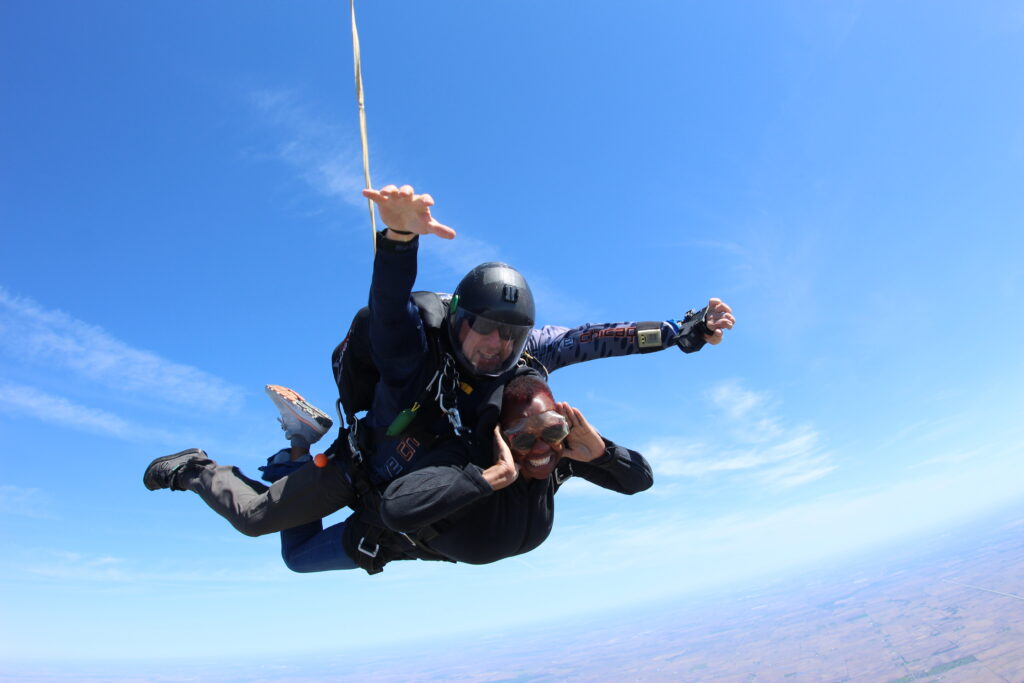 tandem skydivers posing in freefall at Skydive Chicago